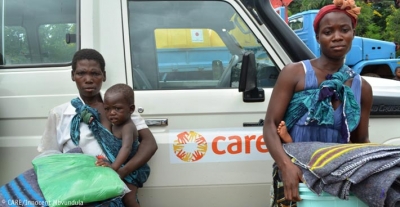 Women holding emergency supplies provided by CARE following flooding in Malawi, January 2015