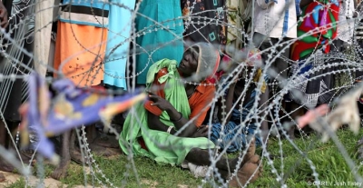 A woman queuing outside a camp for internally displaced people in South Sudan