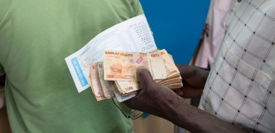Queuing to make a deposit at a bank in Uganda