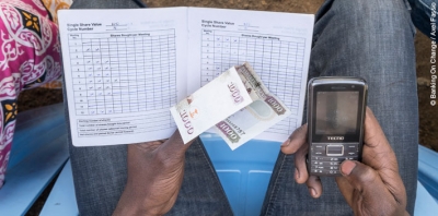 A mobile transaction during a savings group meeting in Kenya