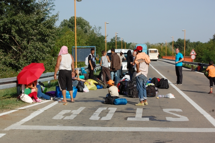 Refugees gathering by a roadside in Serbia