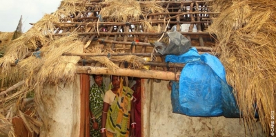 Women take stock of the damage done to their home by the cyclone that struck Odisha in October 2013