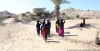 Women in Lahj, Yemen, carrying water they collected from a CARE water point