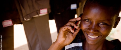 Lillian Adiambe, a young entrepreneur in Kenya, making a call on her mobile phone