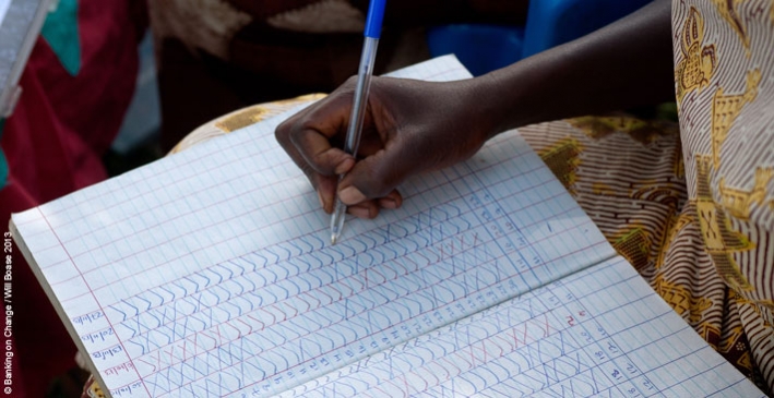 Beatrice Alowo, 43, Secretary of the Yesu Amala VSLA group in Busia District, Eastern Uganda, takes a roll-call of members before commencing a meeting