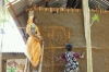 Finishing touches to the walls on a new home - built after the recent floods in Orissa, India, to withstand future floods. © Philip Barritt / CARE